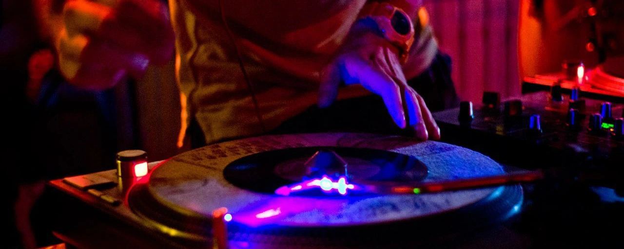 Turntable glowing purple in the club